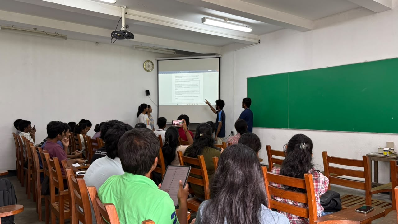 A student presenting in a lecture room
