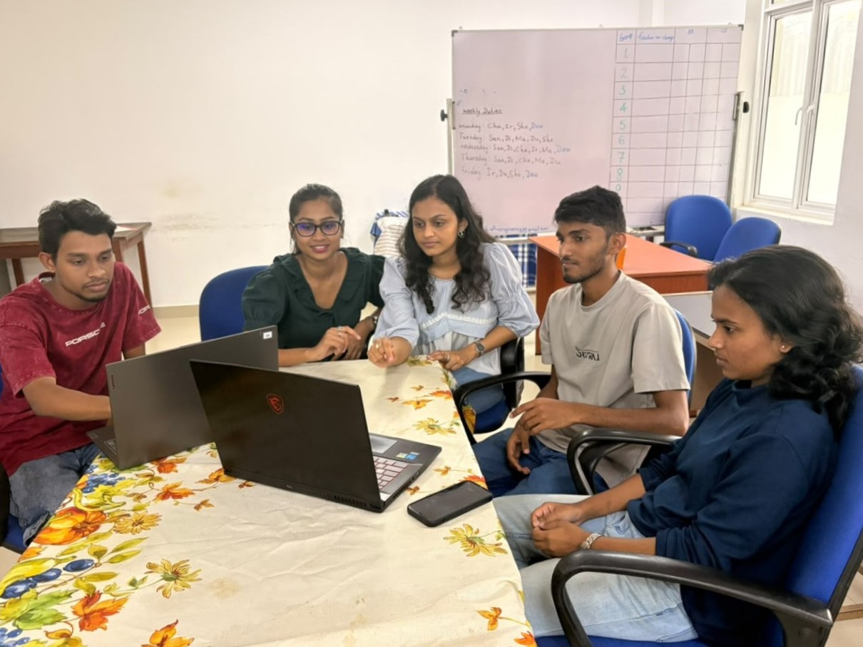 A lecturer reviewing work with students